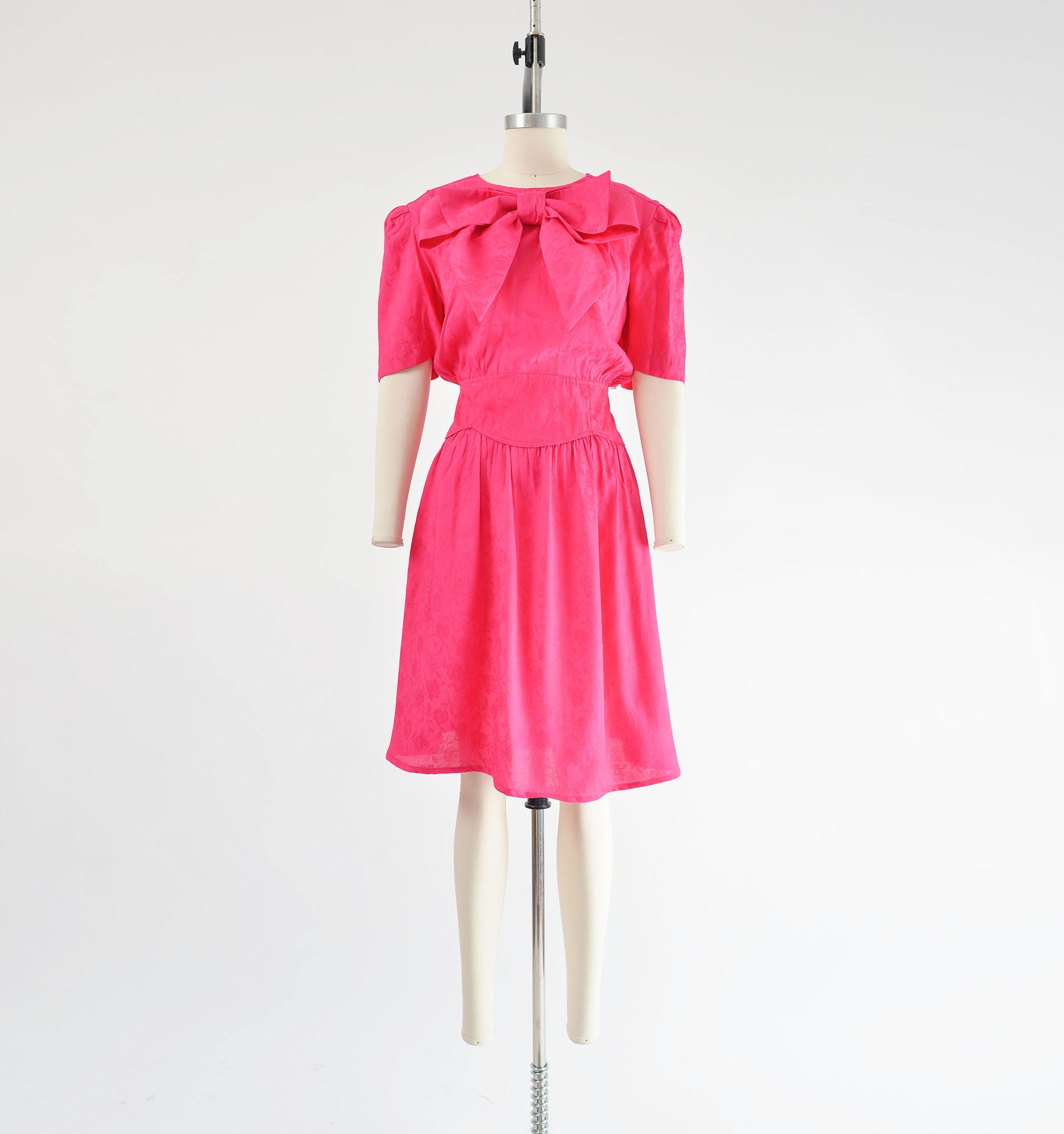 Vintage 80s pink dress with large bow at the neck. Blouson silhouette with wide waistband.