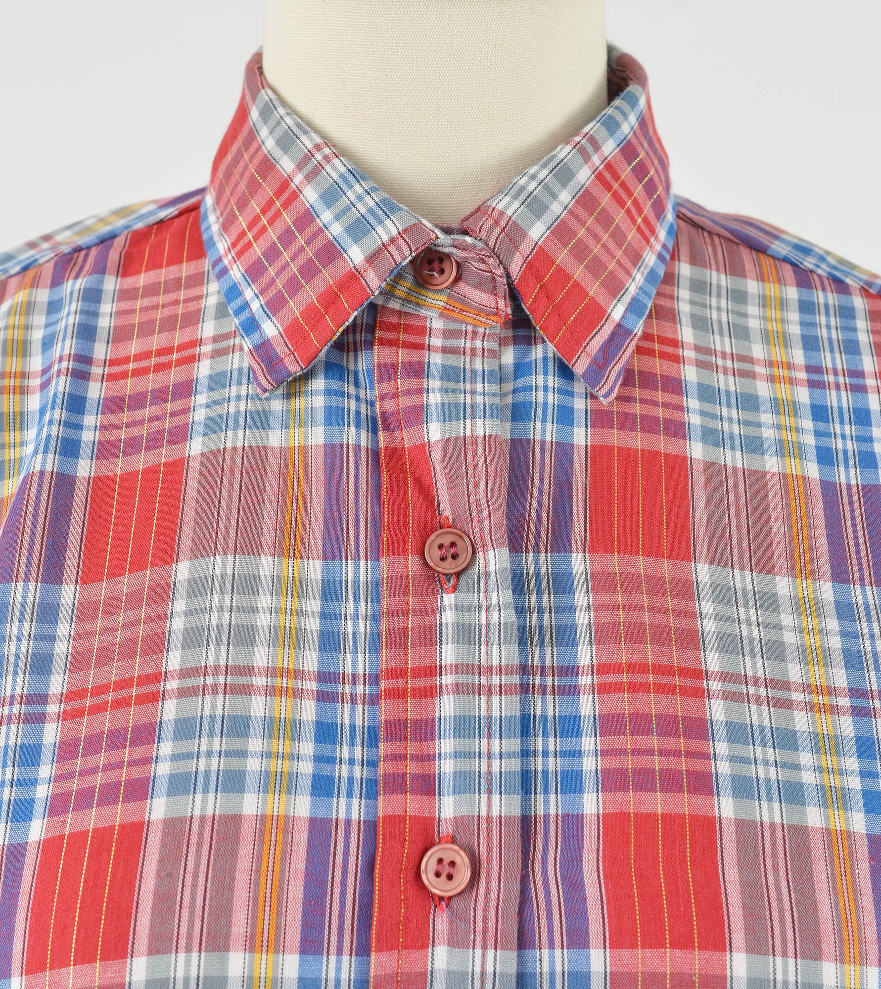 Close up view of vintage red plaid western shirt.