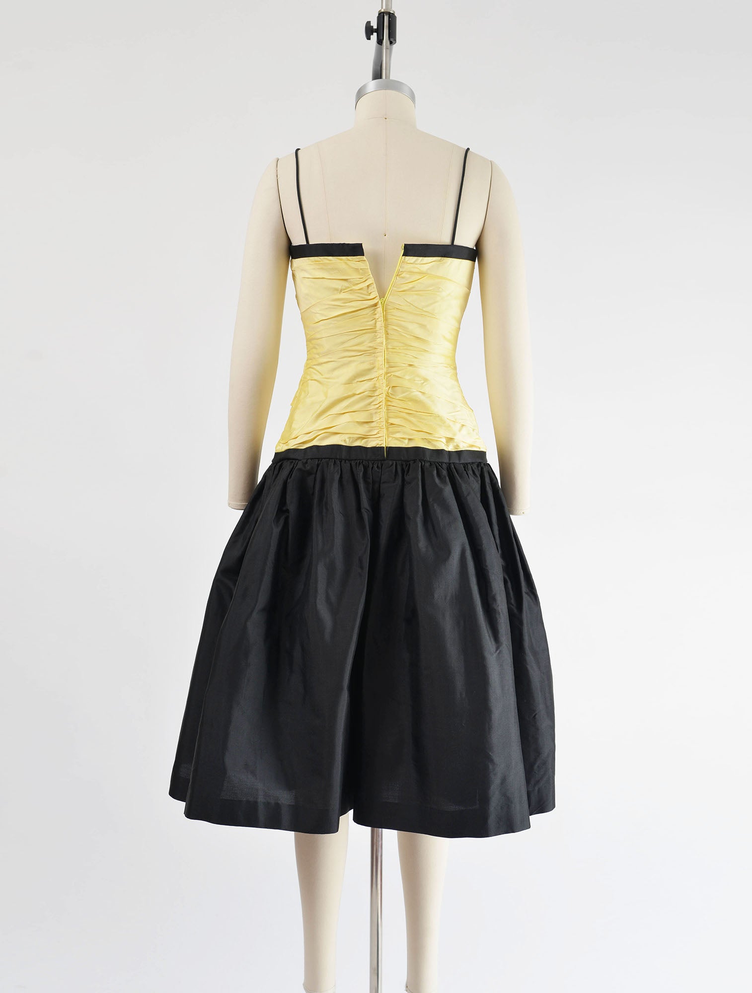 Rear view of yellow and black dress.