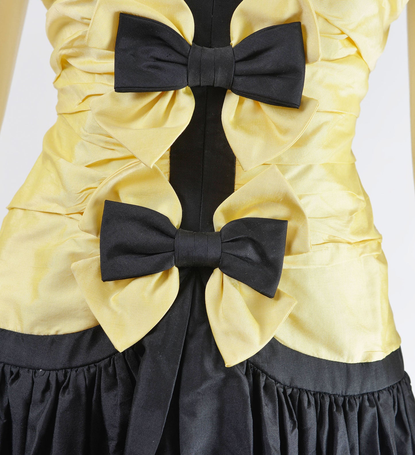 Close up of two bows on the dress. 