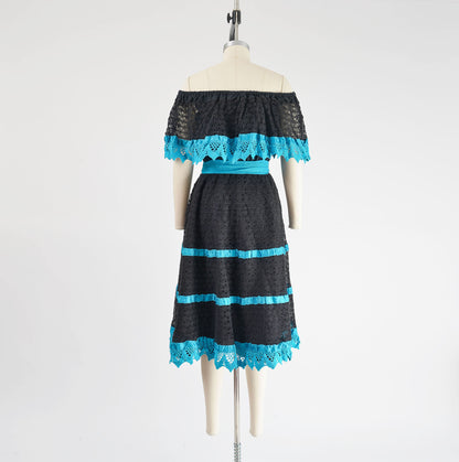 Full back view of 1980s black and blue sheer lace Mexican dress with off shoulder neckline.