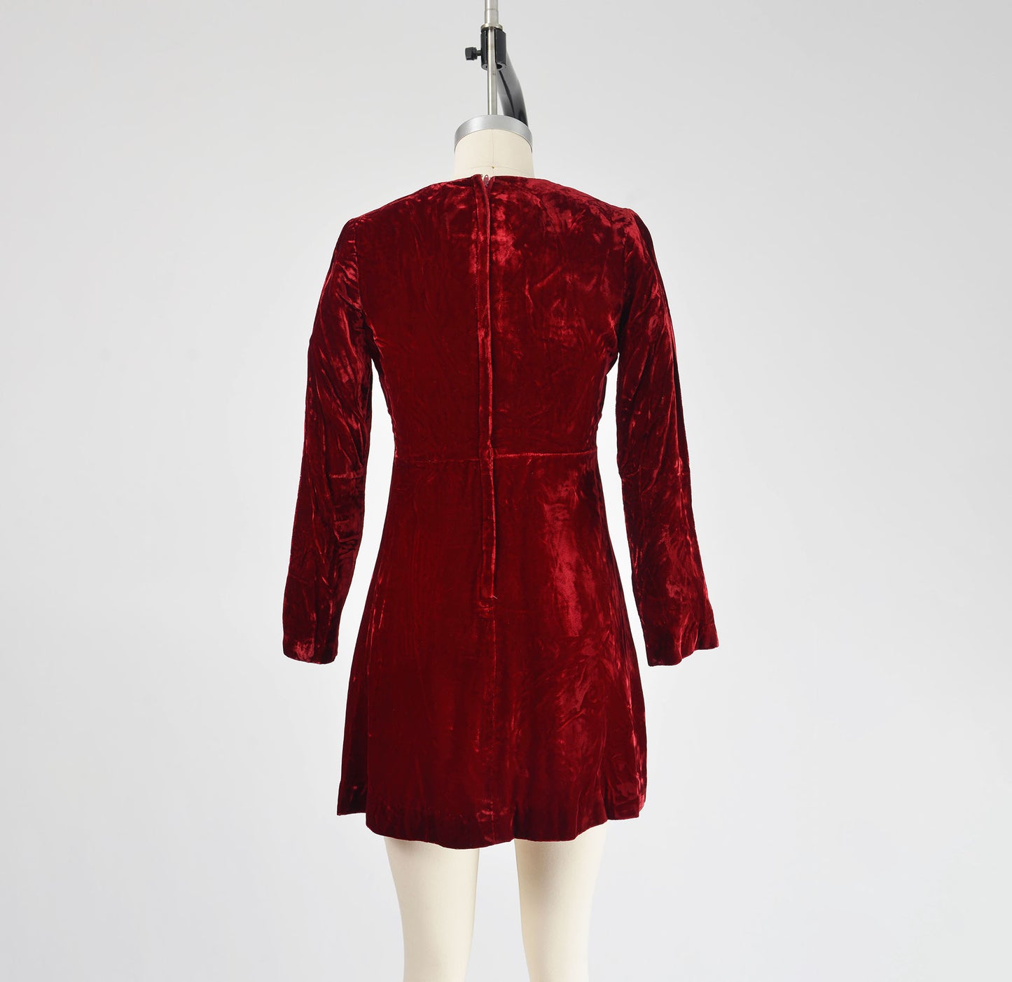 Full length back view of 70s burgundy red velvet mini dress.