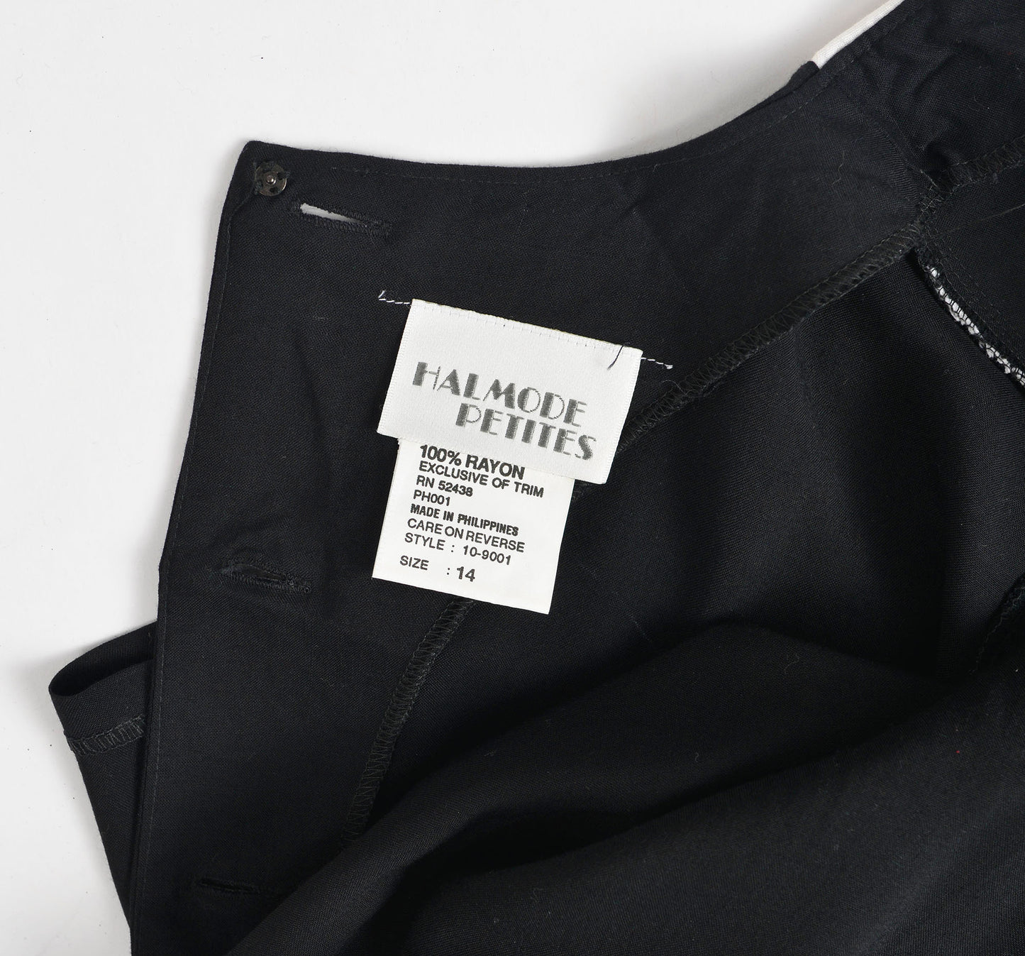 Close up view of designer label inside the back neckline.