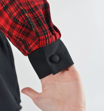 Close up view of sleeve cuff with button closure.