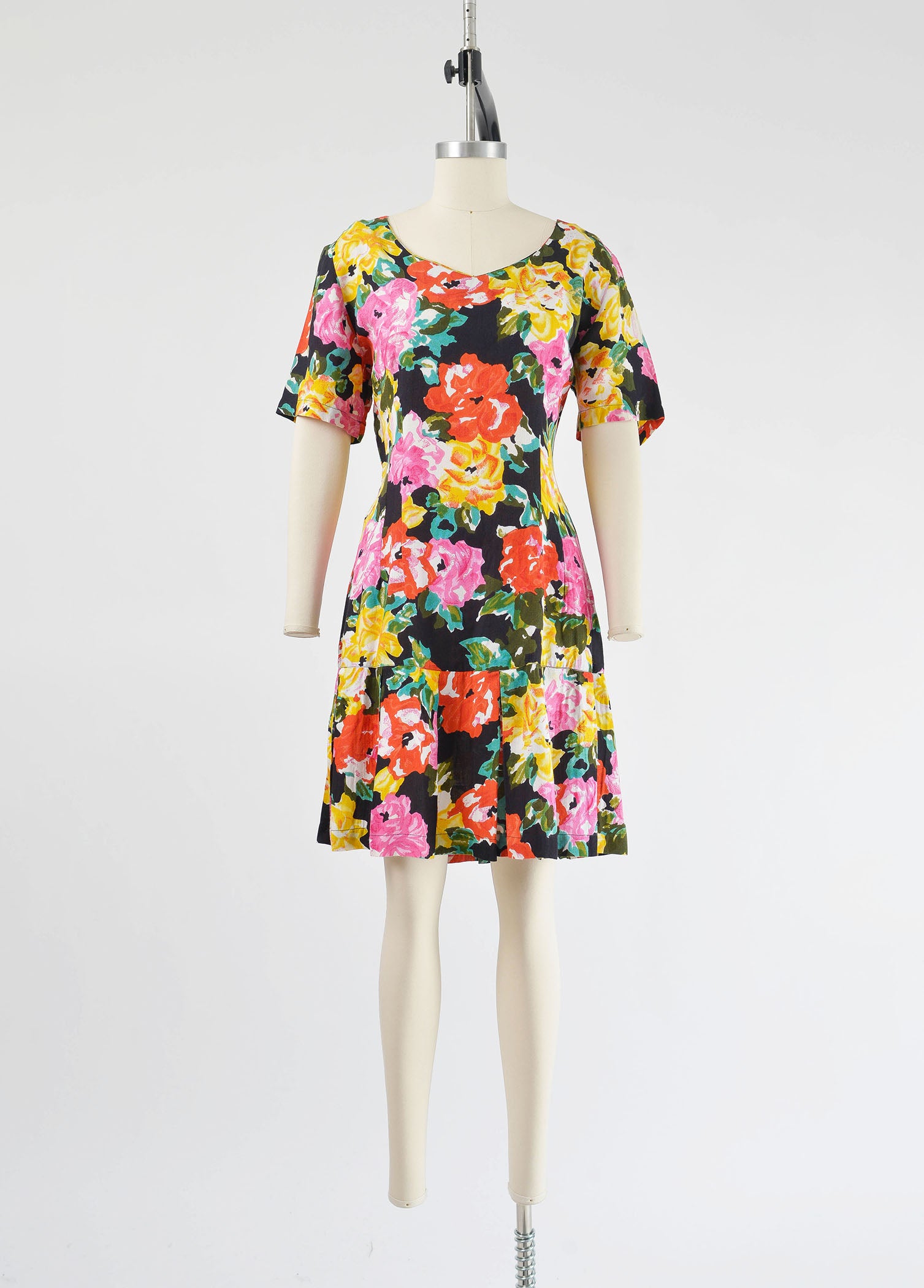 Full front view of vintage 90s colorful floral print dress. Sheath silhouette with pleated hem.