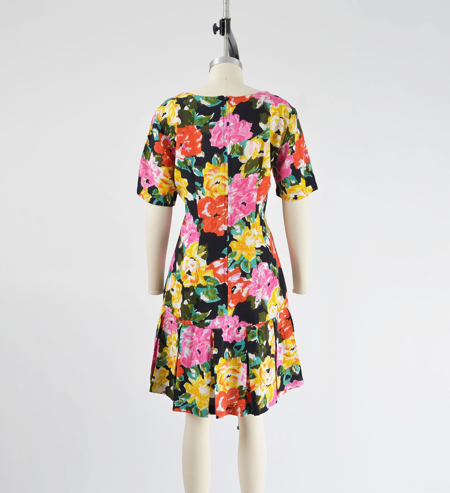 Full back view vintage 90s colorful floral print dress. Sheath silhouette with pleated hem.