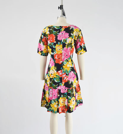 Full back view vintage 90s colorful floral print dress. Sheath silhouette with pleated hem.