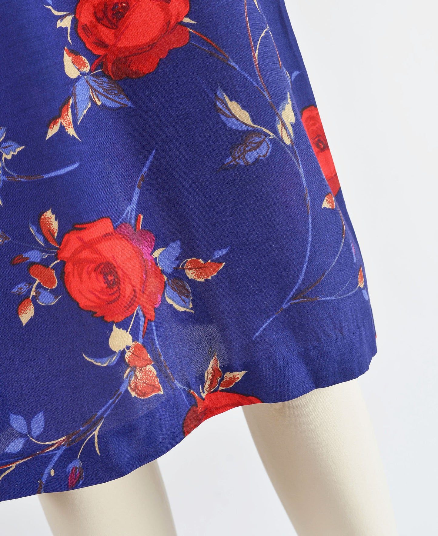 Close up view of purple floral print fabric on dress.