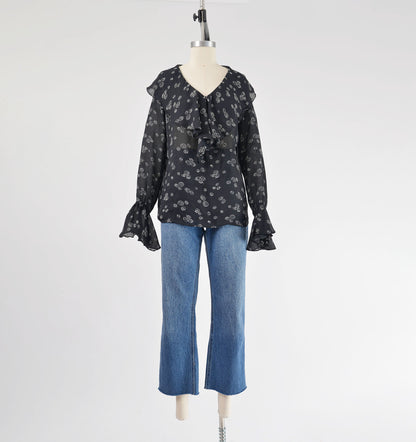 Full view of Vintage Black and white sheer poet blouse with ruffle neckline styled with jeans.