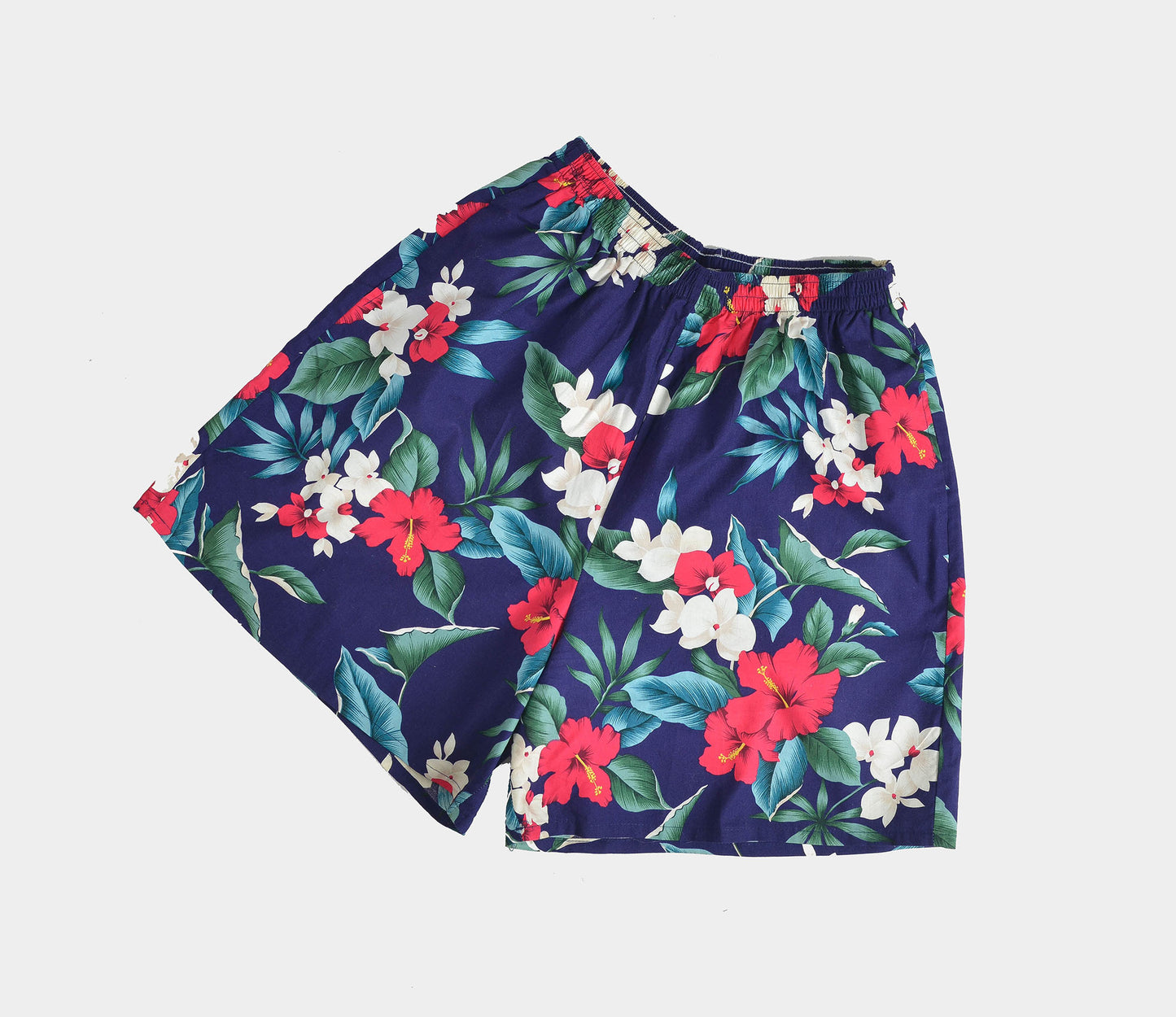 Flat view of vintage Hawaiian floral print cotton shorts.