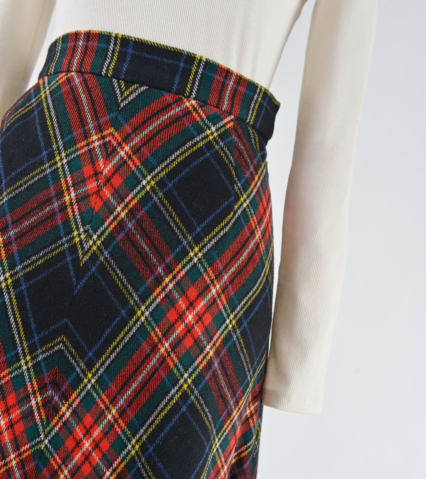 Close up view of tartan plaid wool maxi skirt.