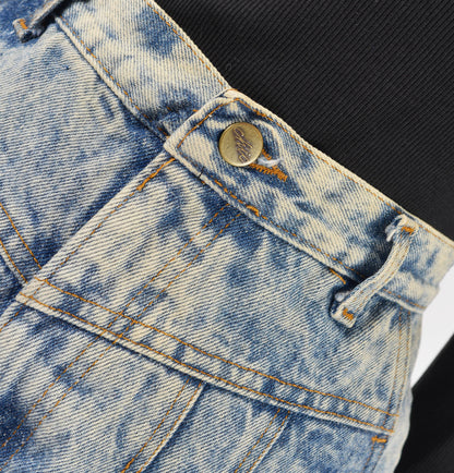 Chic vintage acid wash jeans with yoke waistline. Close up view of waist.