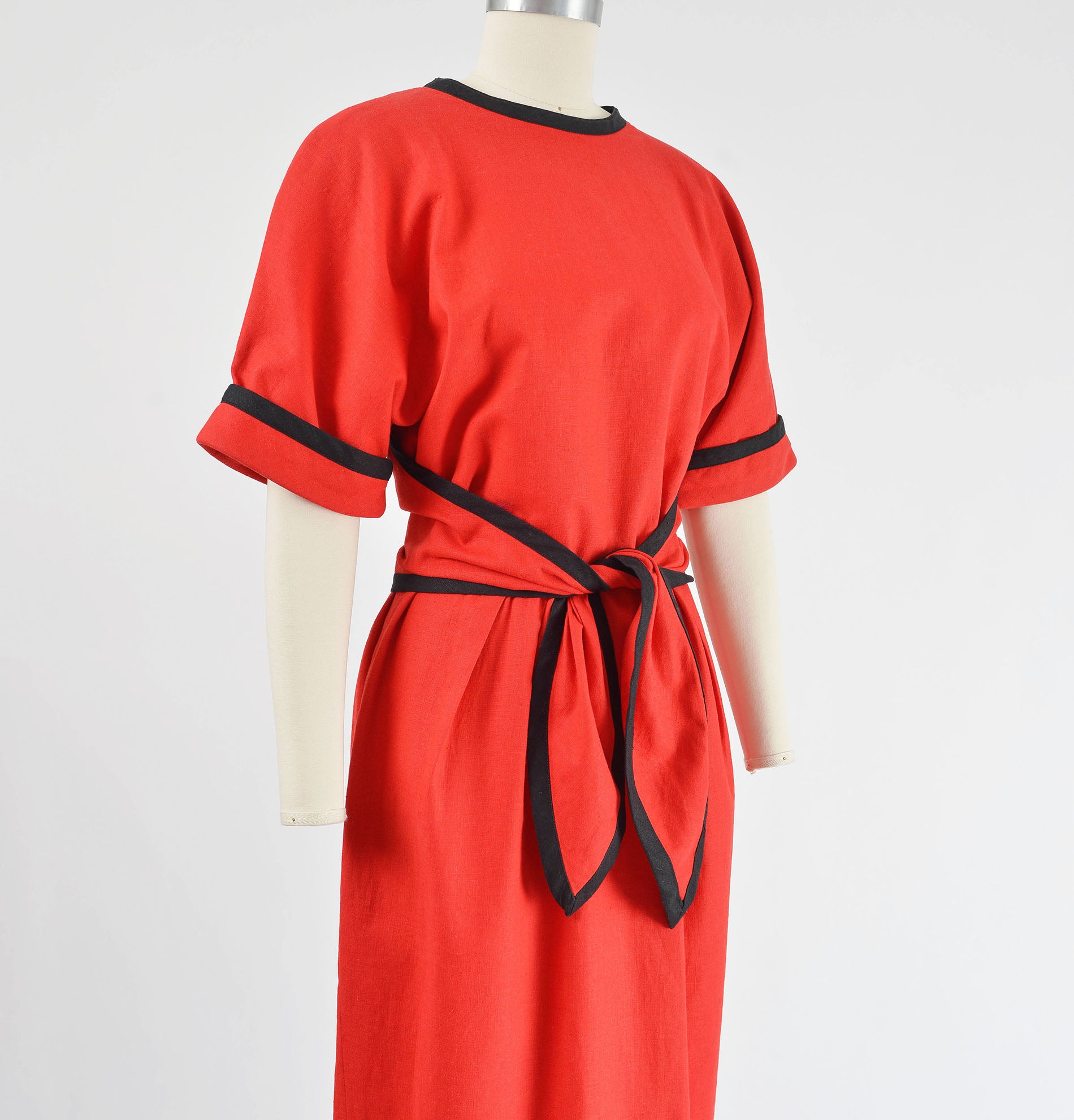 Side view of red linen dress with tie waist.