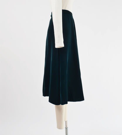 Side view of 80s dark green velvet midi skirt.