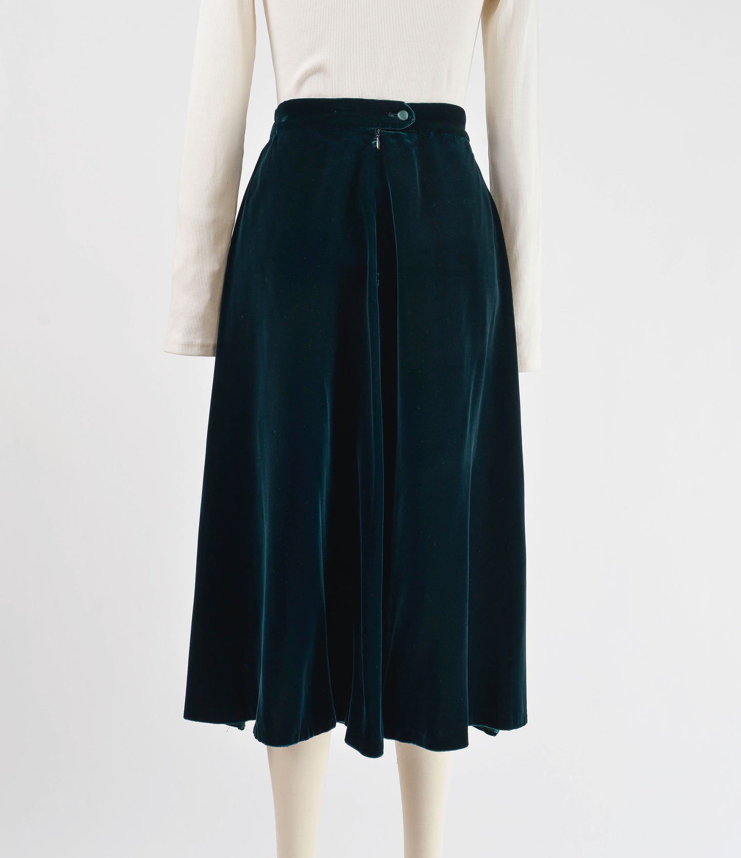 Full back view of dark green velvet midi skirt. 