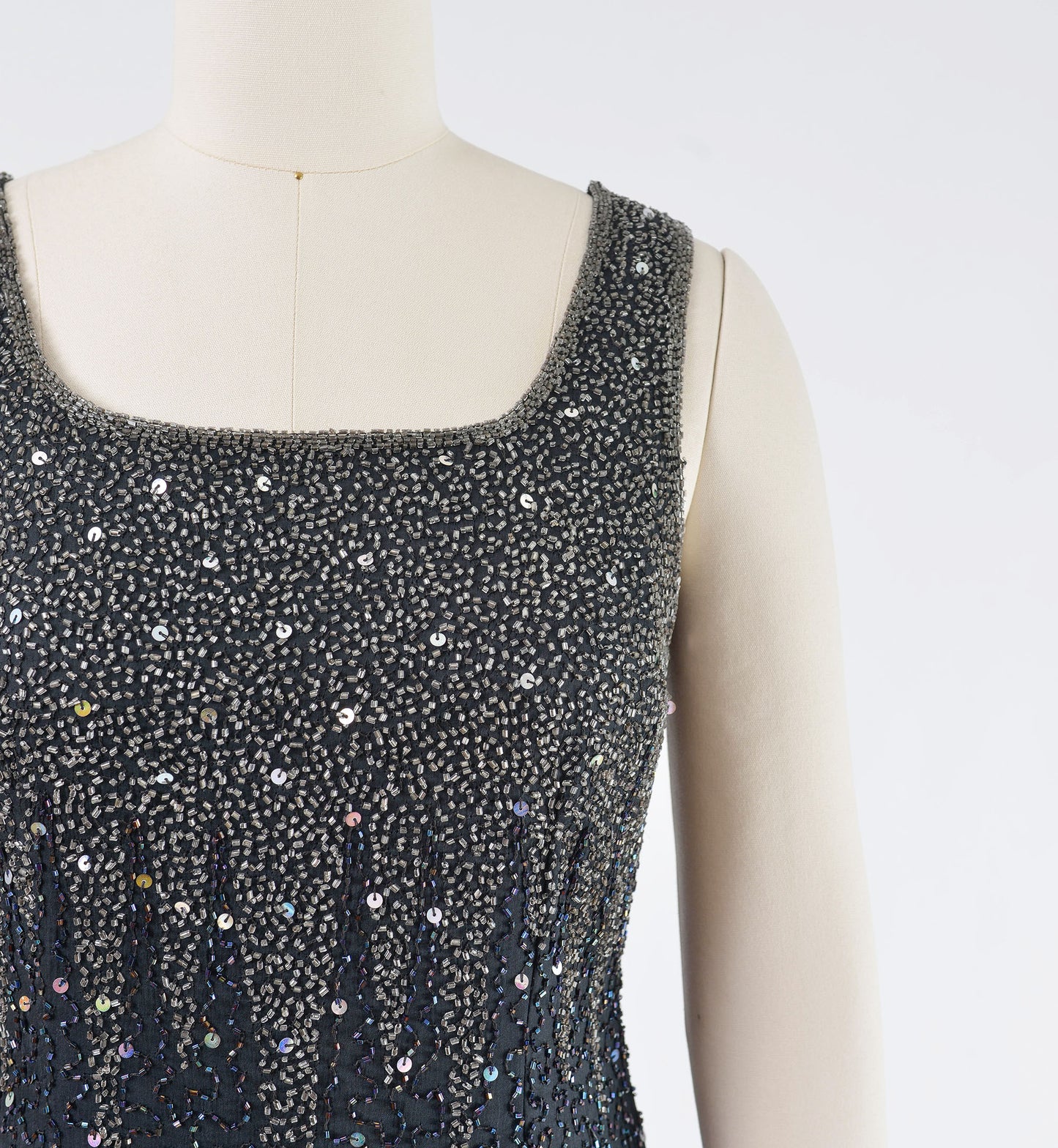 Close up view of silver beading and sequins.