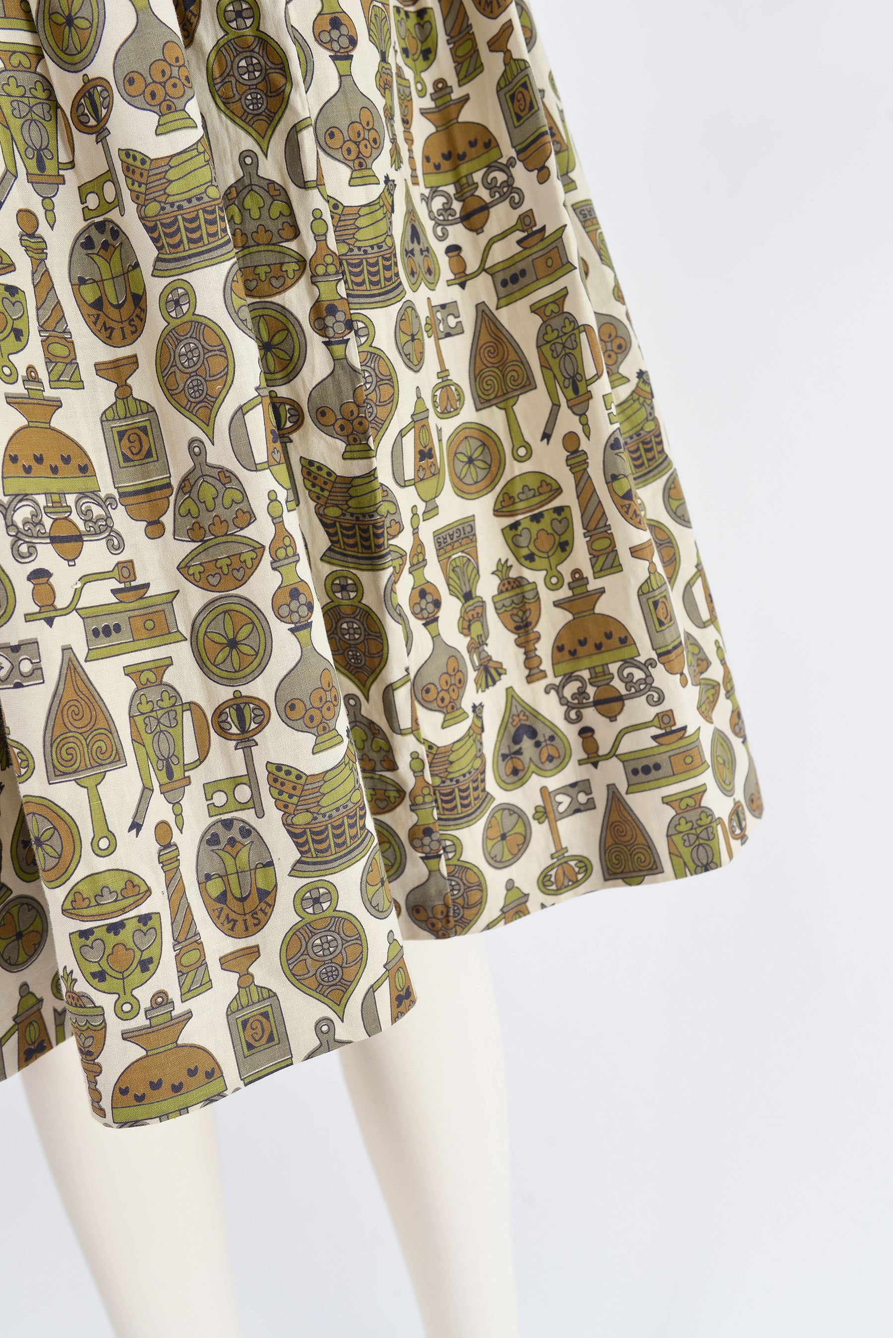 Close up view of the hemline on 60s vintage novelty print dress.