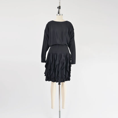 Full view of vintage 80s black batwing sleeves dress with flounce ruffle skirt.