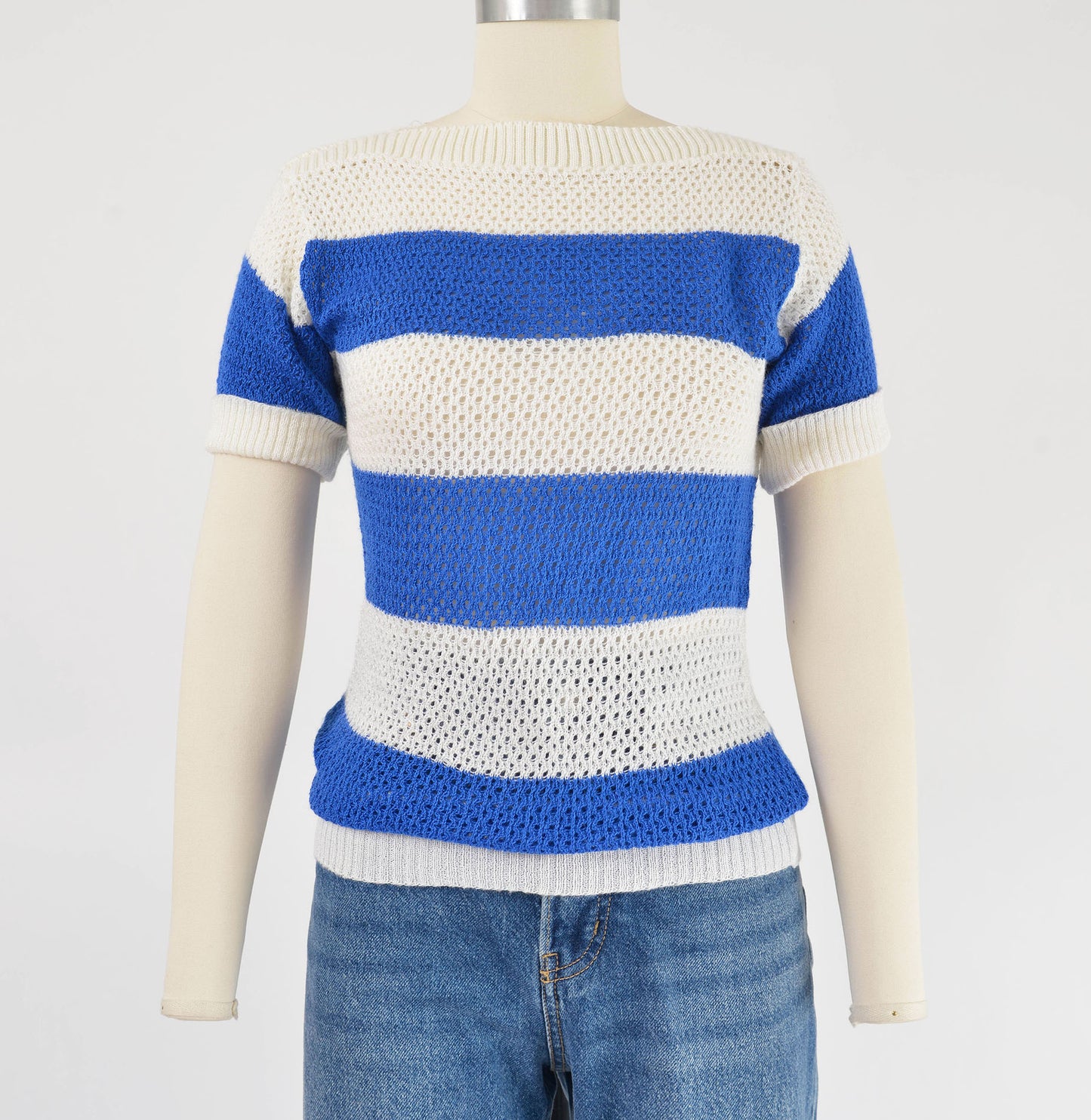 Front view of  1980s blue and white striped sweater. Semi sheer open knit top with short sleeves. 