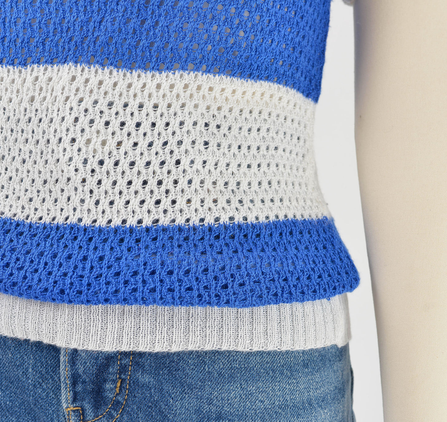 Close up view of blue and white striped knit sweater.