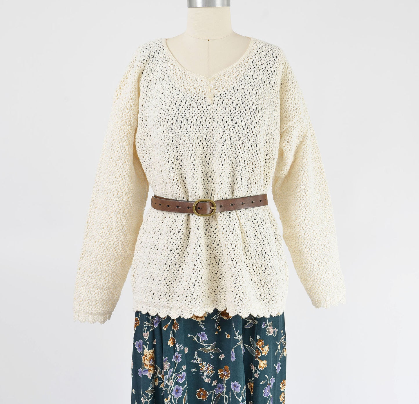 Vintage 1990s of white cotton sweater styled over a dress with belt. 