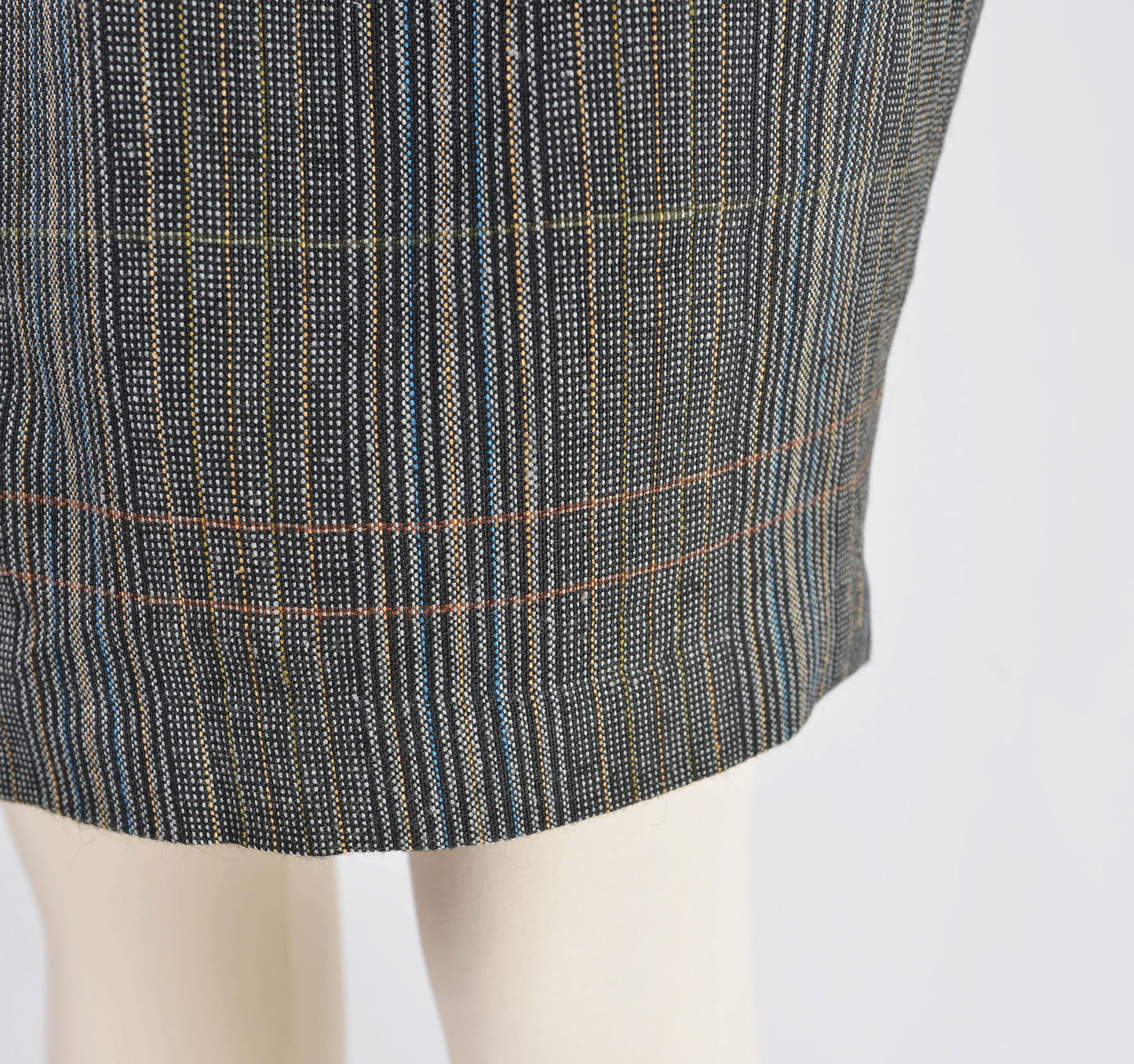 Close up view of plaid fabric on skirt.