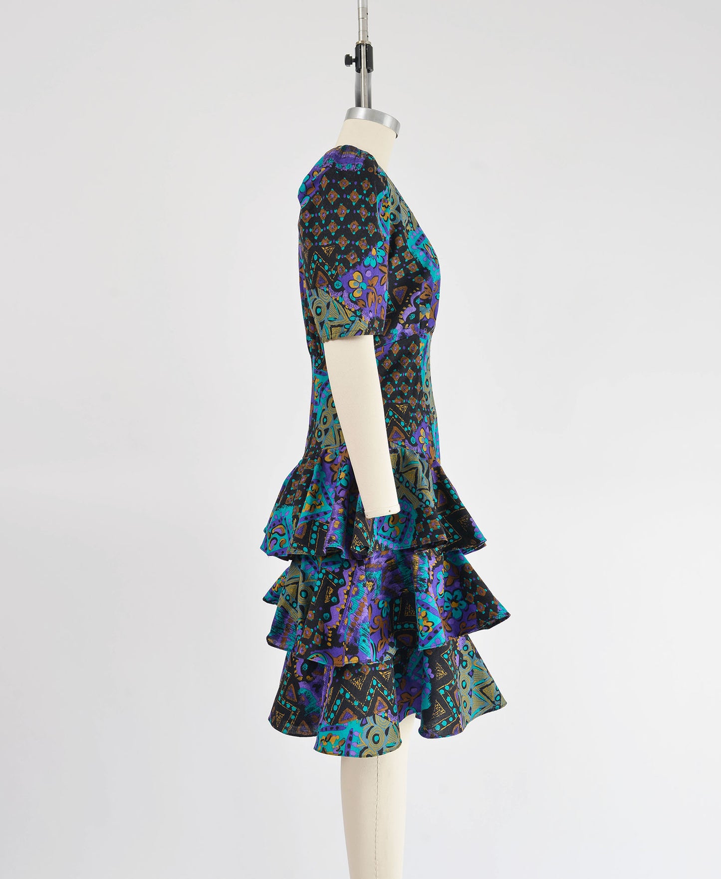 Side view of vintage 80s abstract print cotton dress with tiered ruffle skirt.