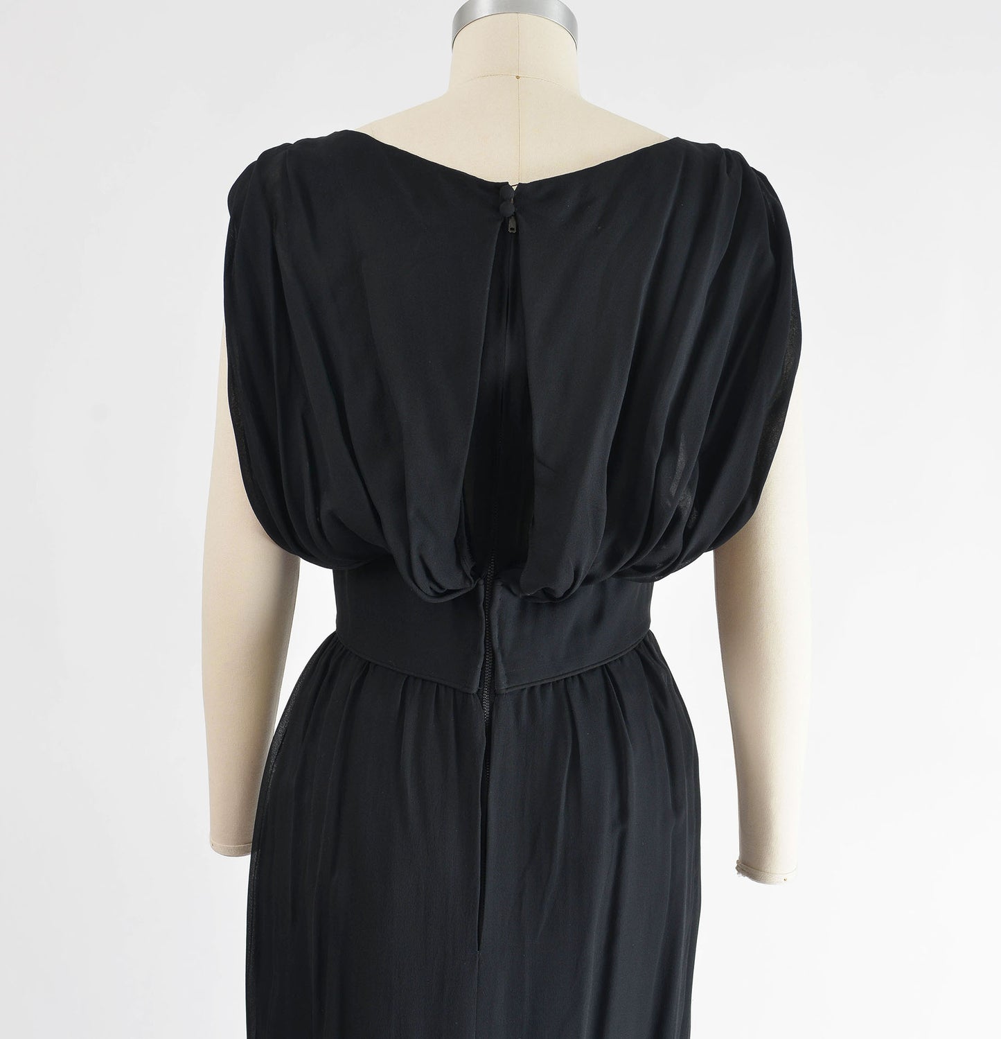 Close up back view of 1960's black chiffon cocktail dress. 