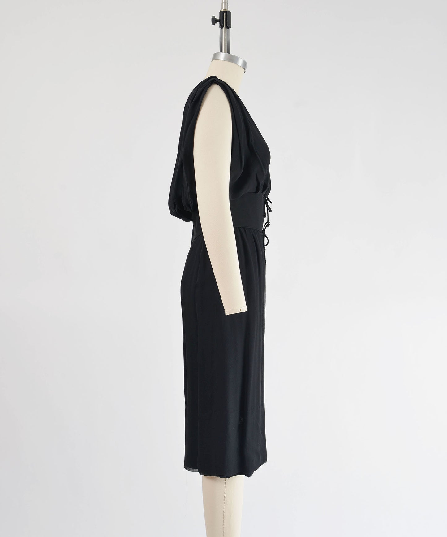 Side view of 1960's black chiffon cocktail dress. 