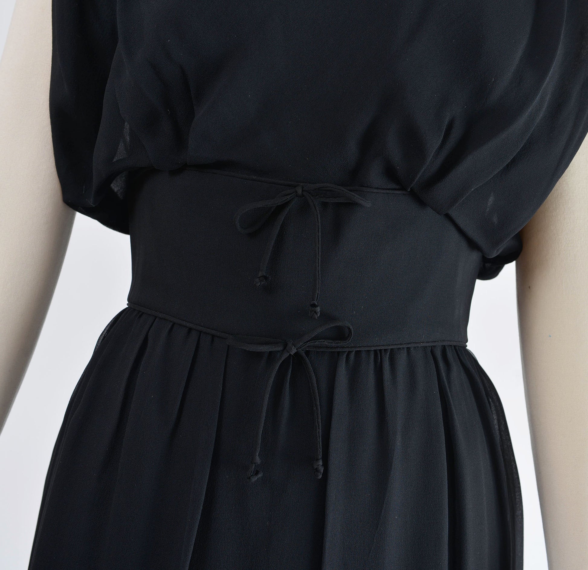 Front waistline with two tiny bows. 1960's black cocktail dress. 