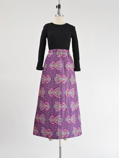 Full view vintage 70s purple paisley print quilted maxi skirt.