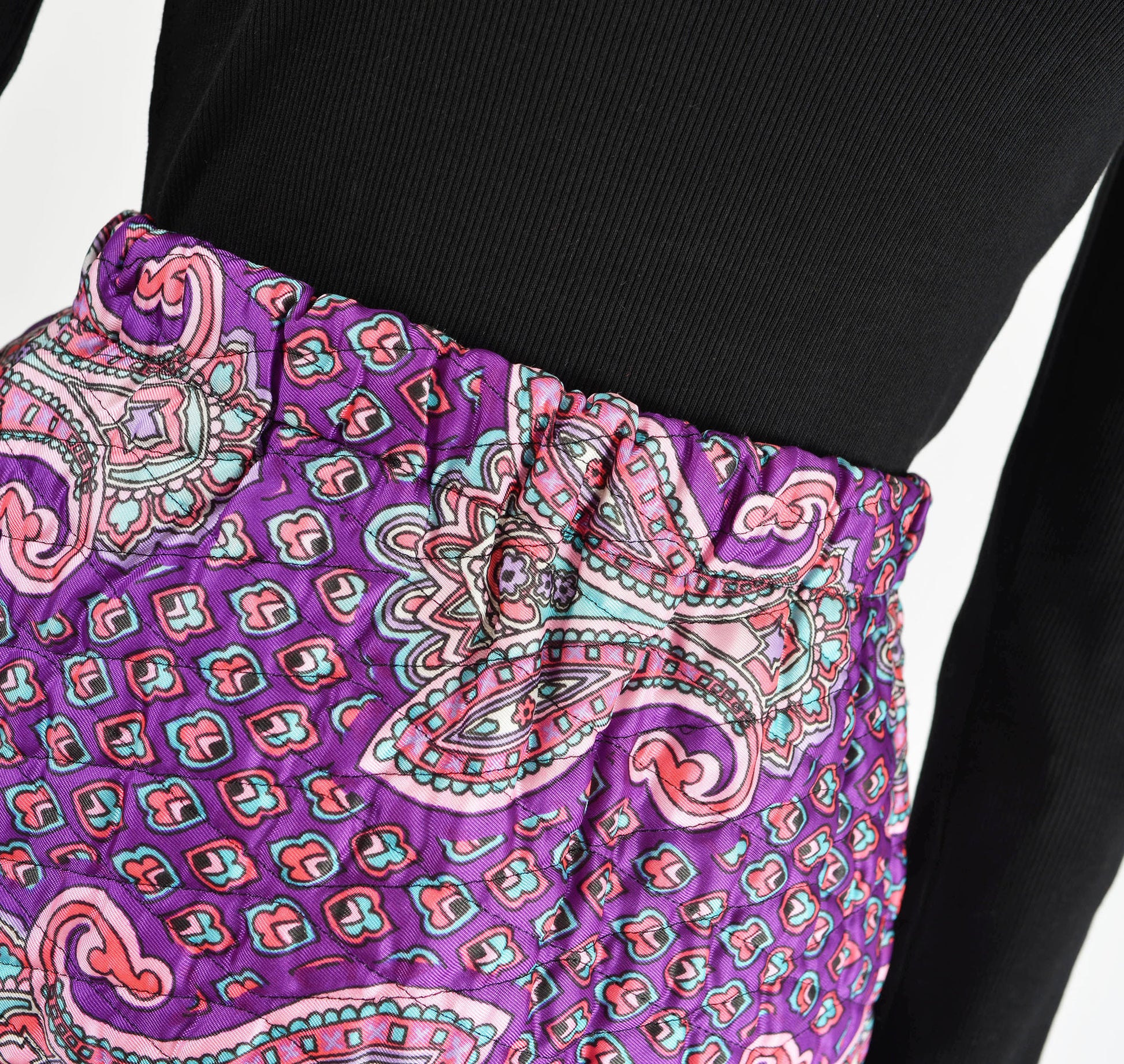 Close up view of  waistline on 70s purple paisley print quilted maxi skirt.